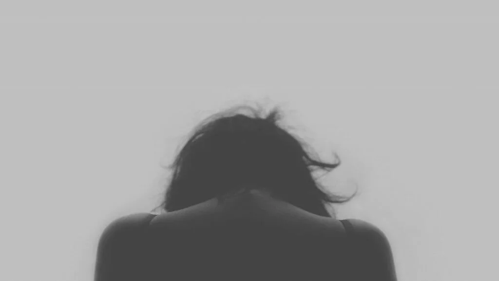 Black and white photo of a woman deep in thought