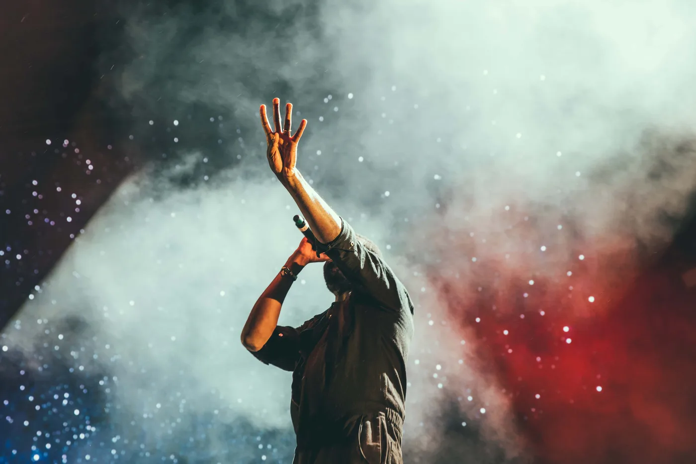 Music producer performing live with expressive hands-on control
