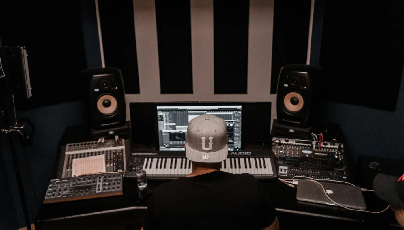 Producer in a studio working through how to know if your music is good