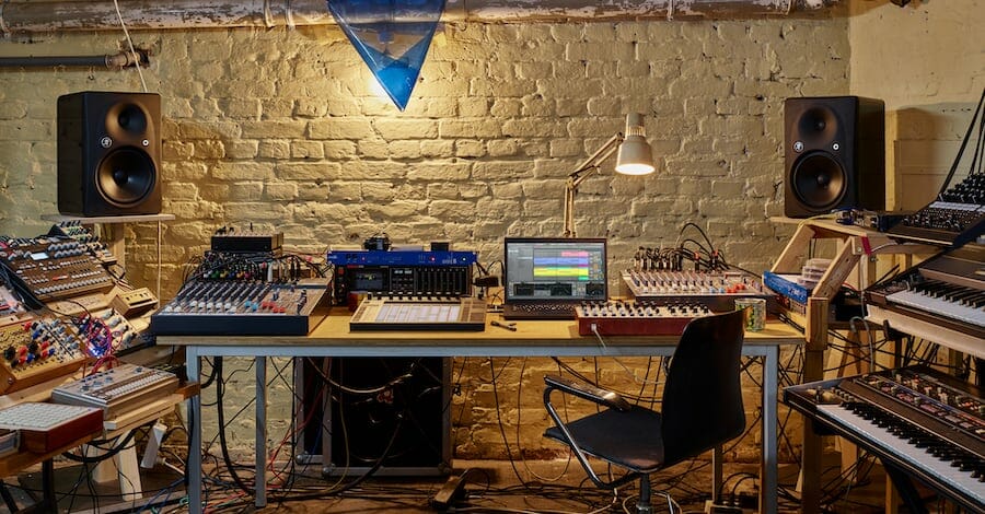 Cave-style home studio from Ableton's creative space, basement setup with moody lighting