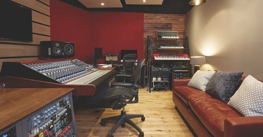 Abbey Road studios, wood, brick, red accent wall and retro leather couch