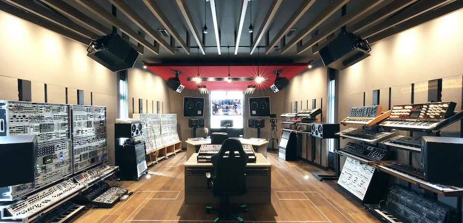 Deadmau5's studio, gear-heavy setup with hardware wall and clean workflow despite complexity