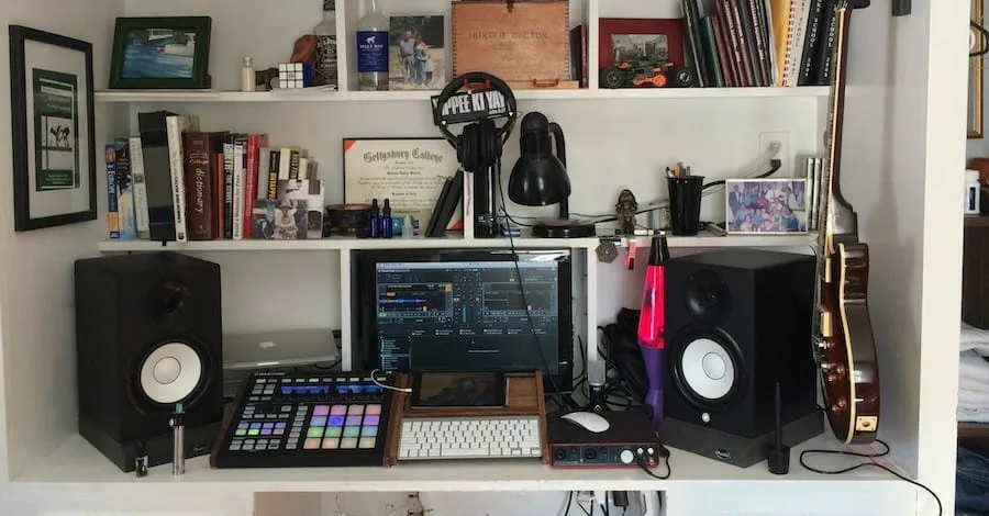 Melodealer small studio, books, shelves and speakers creating a cozy creative space