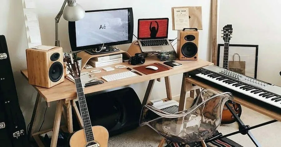 ArchitectureIn small studio, wood-toned speakers, desk and guitar stand creating a beautiful thing