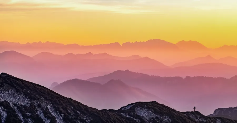 Vivid landscape photograph showing bright warm mountain peaks contrasting dramatically against deep cool shadows, mirroring the tonal separation achieved in the mix