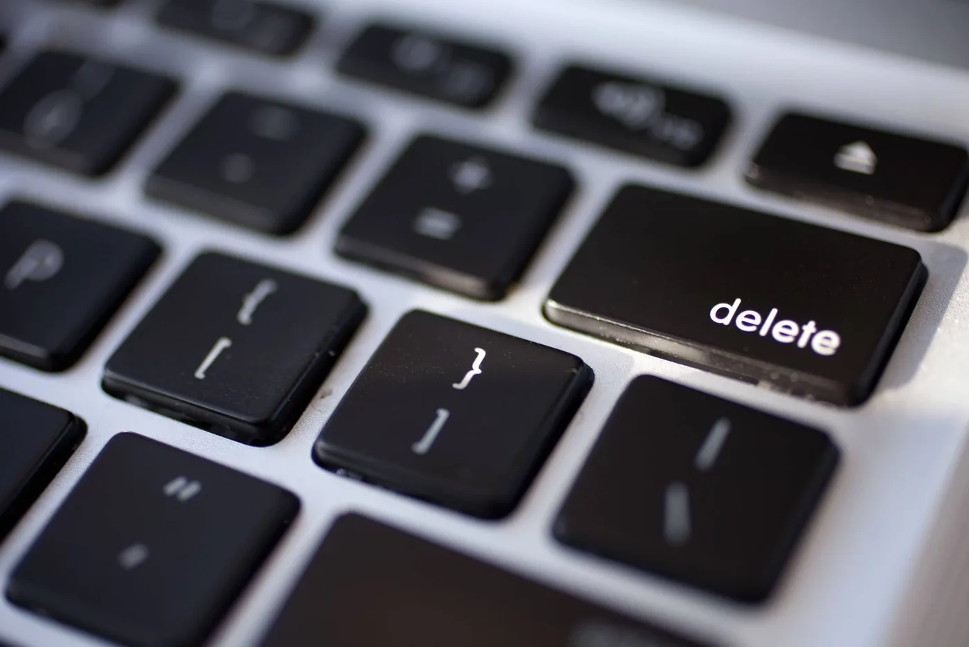 Finger hovering over a large red delete button