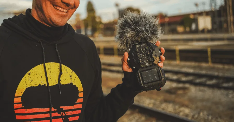 Producer setting up a condenser microphone in a home recording environment