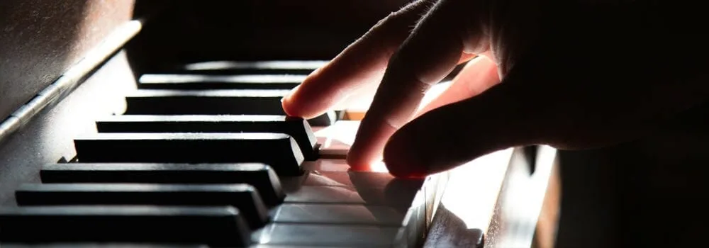Close-up of piano keys being played, capturing the detail of a live performance
