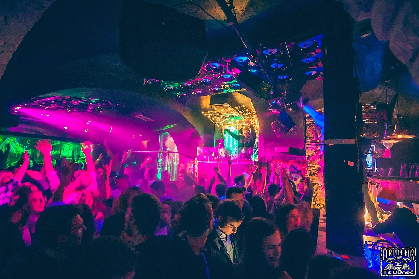 Packed club crowd under pink and green lighting at an Ortox show