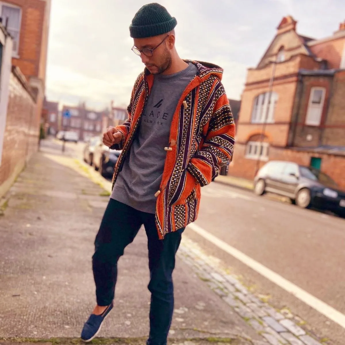 Sam Welch walking a London street in a patterned jacket