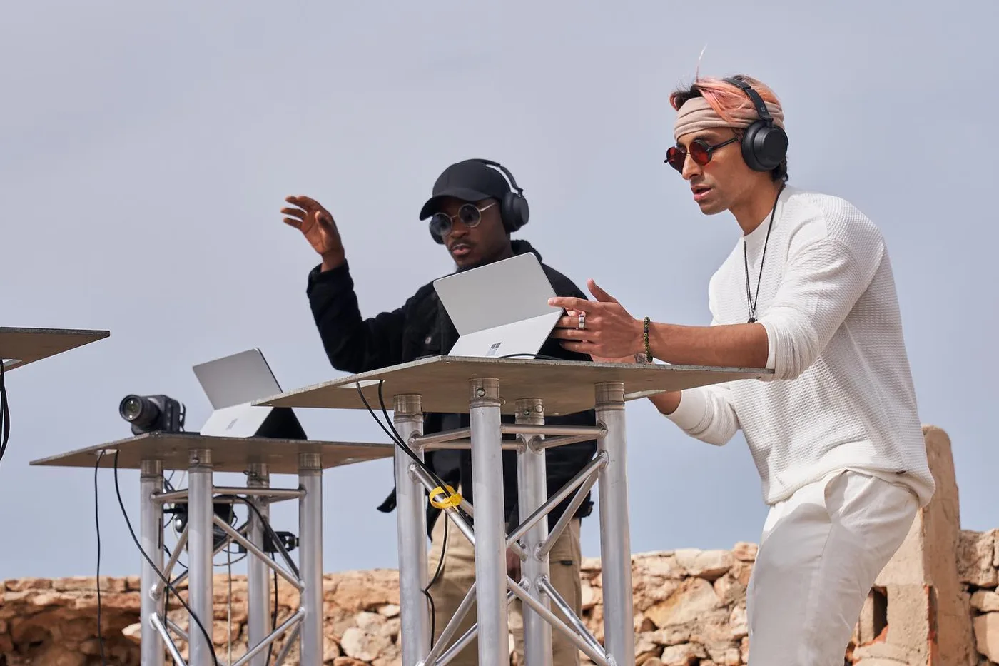 Shishi playing an outdoor daytime Ibiza-style DJ set from a stone ruin stage