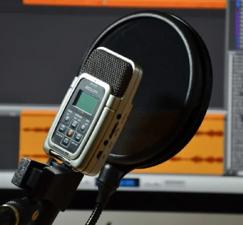 Studio pop filter on a gooseneck clip to prevent plosives in vocal recordings